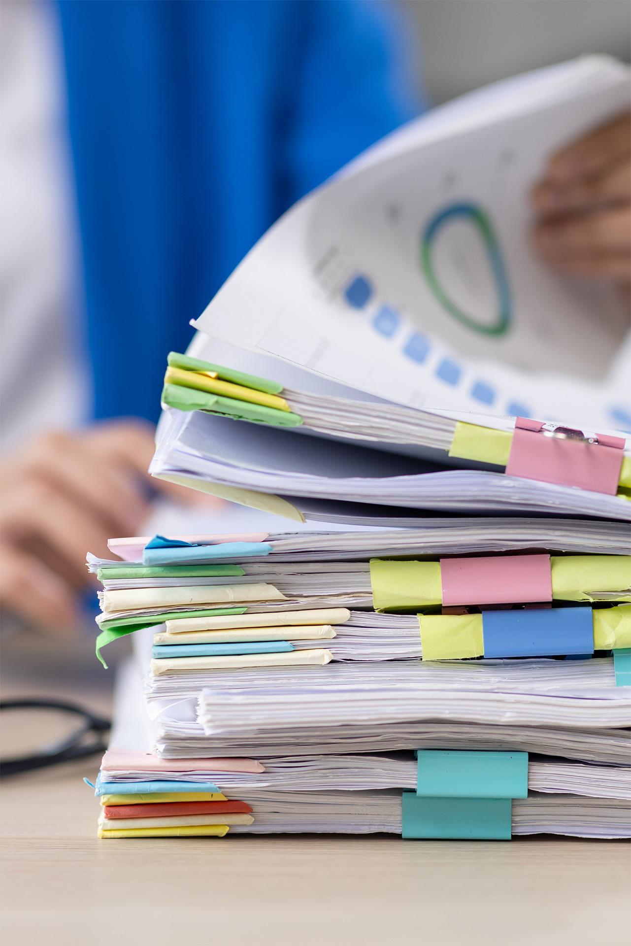 stack-of-documents-and-businesswoman-in-the-workpl-2026-03-19-06-53-01-utc